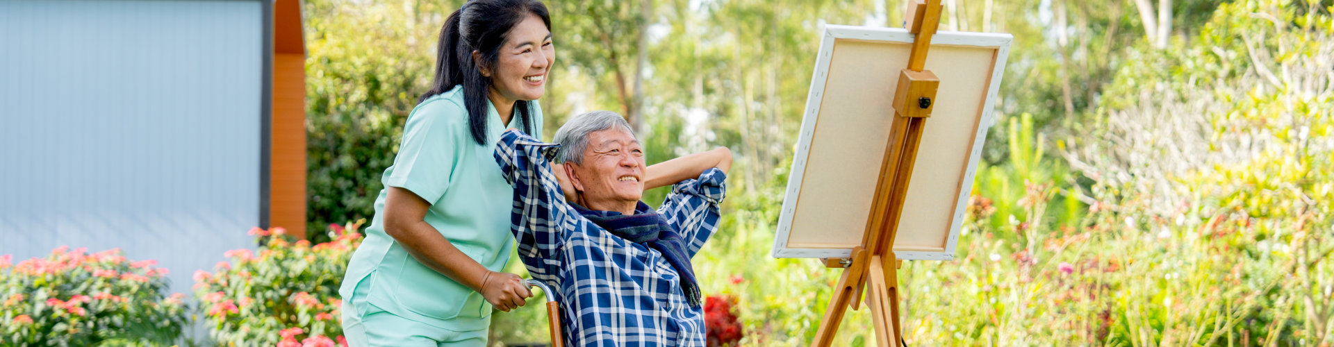 caregiver and elderly looking at the painting